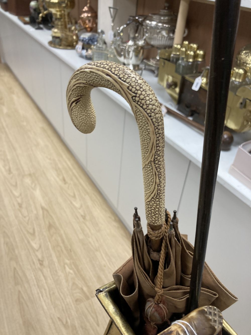 A carved tripod vase stand, an Arts & Crafts hammered brass vase, height 56cm, two umbrellas and two walking sticks